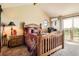 This bedroom has a vaulted ceiling, balcony access, natural light, and comfortable furnishings at 3191 W 151St Ct, Broomfield, CO 80023
