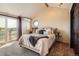 Bright bedroom with neutral colors, a balcony and a door leading to exterior living and outdoor views at 3191 W 151St Ct, Broomfield, CO 80023
