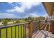View from the deck overlooking a green lawn, wooden fence, and mountains in the distance at 3191 W 151St Ct, Broomfield, CO 80023