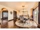 Cozy dining area with a round table, hardwood floors, and large windows with natural light at 3191 W 151St Ct, Broomfield, CO 80023