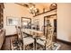 Formal dining room with hardwood floors, beautiful chandelier, and large windows with natural light at 3191 W 151St Ct, Broomfield, CO 80023