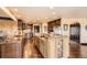 Spacious kitchen featuring stainless steel appliances, a large island, and dark wood cabinets at 3191 W 151St Ct, Broomfield, CO 80023