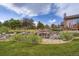 Backyard landscaping featuring a rock garden with a small waterfall and green lawn at 3191 W 151St Ct, Broomfield, CO 80023