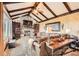 The living room has a stone fireplace, beamed ceiling, and comfortable seating with an elegant interior design at 3191 W 151St Ct, Broomfield, CO 80023