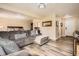 Comfortable living room space with plush sectional couch, hardwood floors, and access to bedroom at 3191 W 151St Ct, Broomfield, CO 80023