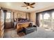 This luxurious bedroom features a four-poster bed, textured walls, a private balcony, and abundant natural light at 3191 W 151St Ct, Broomfield, CO 80023