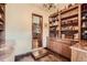 A well-organized pantry boasts custom shelving, ample storage, and a chandelier for added elegance at 3191 W 151St Ct, Broomfield, CO 80023