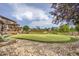 Backyard putting green area, surrounded by rock features and lush landscaping at 3191 W 151St Ct, Broomfield, CO 80023