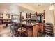 Entertaining at home featuring a basement wet bar with bar stool seating and bar shelving at 3191 W 151St Ct, Broomfield, CO 80023