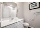 Bathroom featuring modern sink, light fixtures, large mirror, and tile floors at 185 Ambrose St, Erie, CO 80516