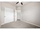 This bedroom features carpeted floors, a ceiling fan, and a large closet at 185 Ambrose St, Erie, CO 80516