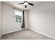 Neutral bedroom featuring a ceiling fan and a window with a dark curtain at 185 Ambrose St, Erie, CO 80516