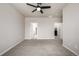 Neutral bedroom with soft gray carpet, ceiling fan, and doors to bathroom and closet at 185 Ambrose St, Erie, CO 80516