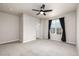 Bedroom featuring a ceiling fan and a window with dark curtains for natural light at 185 Ambrose St, Erie, CO 80516