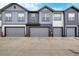 Exterior view of attached garages in a modern townhouse complex at 185 Ambrose St, Erie, CO 80516