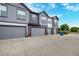 Modern townhouses showcasing garages, with blue recycling bins visible at 185 Ambrose St, Erie, CO 80516