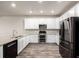 Modern kitchen featuring stainless steel appliances, white cabinets, and granite countertops at 185 Ambrose St, Erie, CO 80516