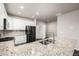 Kitchen featuring stainless steel appliances, white cabinets, and granite countertops at 185 Ambrose St, Erie, CO 80516