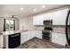 Kitchen featuring stainless steel appliances, white cabinets, and granite countertops at 185 Ambrose St, Erie, CO 80516