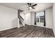 Spacious living room with wood flooring, staircase and a window at 185 Ambrose St, Erie, CO 80516