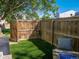 Fenced backyard with turf, seating, and fire pit, creating a private outdoor living area at 16320 E Radcliff Pl # A, Aurora, CO 80015