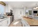 Bright kitchen with white cabinetry, stainless steel appliances, and tile backsplash at 16320 E Radcliff Pl # A, Aurora, CO 80015