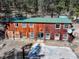 Aerial view of a barn style home with an adjacent concrete pad at 205 Yankee Creek Trl, Evergreen, CO 80439