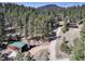 A long driveway leads to a charming house among tall pines, offering a secluded and scenic setting at 205 Yankee Creek Trl, Evergreen, CO 80439