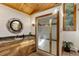 Bathroom with wood ceiling, custom vanity, granite countertop, and walk-in glass shower at 205 Yankee Creek Trl, Evergreen, CO 80439
