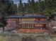Two-story house featuring a deck and patio spaces, perfect for outdoor living and entertaining at 205 Yankee Creek Trl, Evergreen, CO 80439