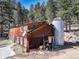 Exterior of barn-style home with silo in a wooded area at 205 Yankee Creek Trl, Evergreen, CO 80439
