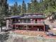 Beautiful home with large windows and a spacious balcony, nestled among tall trees at 205 Yankee Creek Trl, Evergreen, CO 80439