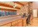 Bright home office with wood ceiling, stone accent wall, built-in desk and storage at 205 Yankee Creek Trl, Evergreen, CO 80439