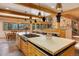 Spacious kitchen with a large island, wood cabinets, modern appliances, and scenic views from the expansive windows at 205 Yankee Creek Trl, Evergreen, CO 80439