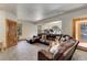 Comfortable Gathering room includes a sectional sofa, neutral carpet and an exercise area in the background at 205 Yankee Creek Trl, Evergreen, CO 80439