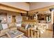Inviting living room featuring a leather sofa, wood beam details and an open layout to the kitchen area at 205 Yankee Creek Trl, Evergreen, CO 80439