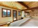 Bedroom featuring wood ceiling with beams and direct access to a private deck at 205 Yankee Creek Trl, Evergreen, CO 80439