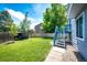 Lush backyard featuring green lawn, a pergola, and a back staircase leading to upper level at 8930 Apache Plume Dr, Parker, CO 80134