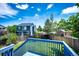 A backyard featuring a blue deck overlooking a fenced yard, lawn, mature trees, and neighboring homes at 8930 Apache Plume Dr, Parker, CO 80134