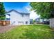 Well-kept backyard features green lawn, a small storage shed, and back stairs to a small deck at 8930 Apache Plume Dr, Parker, CO 80134