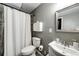 Bathroom with a toilet, vanity, shower curtain, tile floors and gray walls at 8930 Apache Plume Dr, Parker, CO 80134