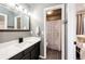 Bathroom features a modern vanity with a framed mirror and a shower with a curtain in the background at 8930 Apache Plume Dr, Parker, CO 80134