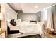 The cozy bedroom features wood floors, recess lighting, a bed, and natural light from the large window at 8930 Apache Plume Dr, Parker, CO 80134