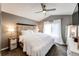 Cozy bedroom with a headboard, gray walls, a ceiling fan, and lots of natural light from the bright window at 8930 Apache Plume Dr, Parker, CO 80134