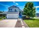 Inviting two-story home with a blue front door and manicured lawn on a sunny day at 8930 Apache Plume Dr, Parker, CO 80134