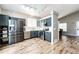 Well-lit kitchen features stainless steel appliances, updated cabinetry, and stylish wood flooring at 8930 Apache Plume Dr, Parker, CO 80134