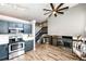 Open living room with vaulted ceilings and a stylish ceiling fan adjacent to the kitchen at 8930 Apache Plume Dr, Parker, CO 80134