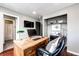 Comfortable home office with sleek design, featuring a built-in shelving and hardwood floors at 8930 Apache Plume Dr, Parker, CO 80134