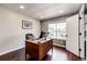 Home office space showcasing a spacious desk, hardwood flooring, and a bright window at 8930 Apache Plume Dr, Parker, CO 80134