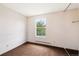 Simple bedroom with window showing green trees and light carpet at 11098 Fairfax Way, Thornton, CO 80233
